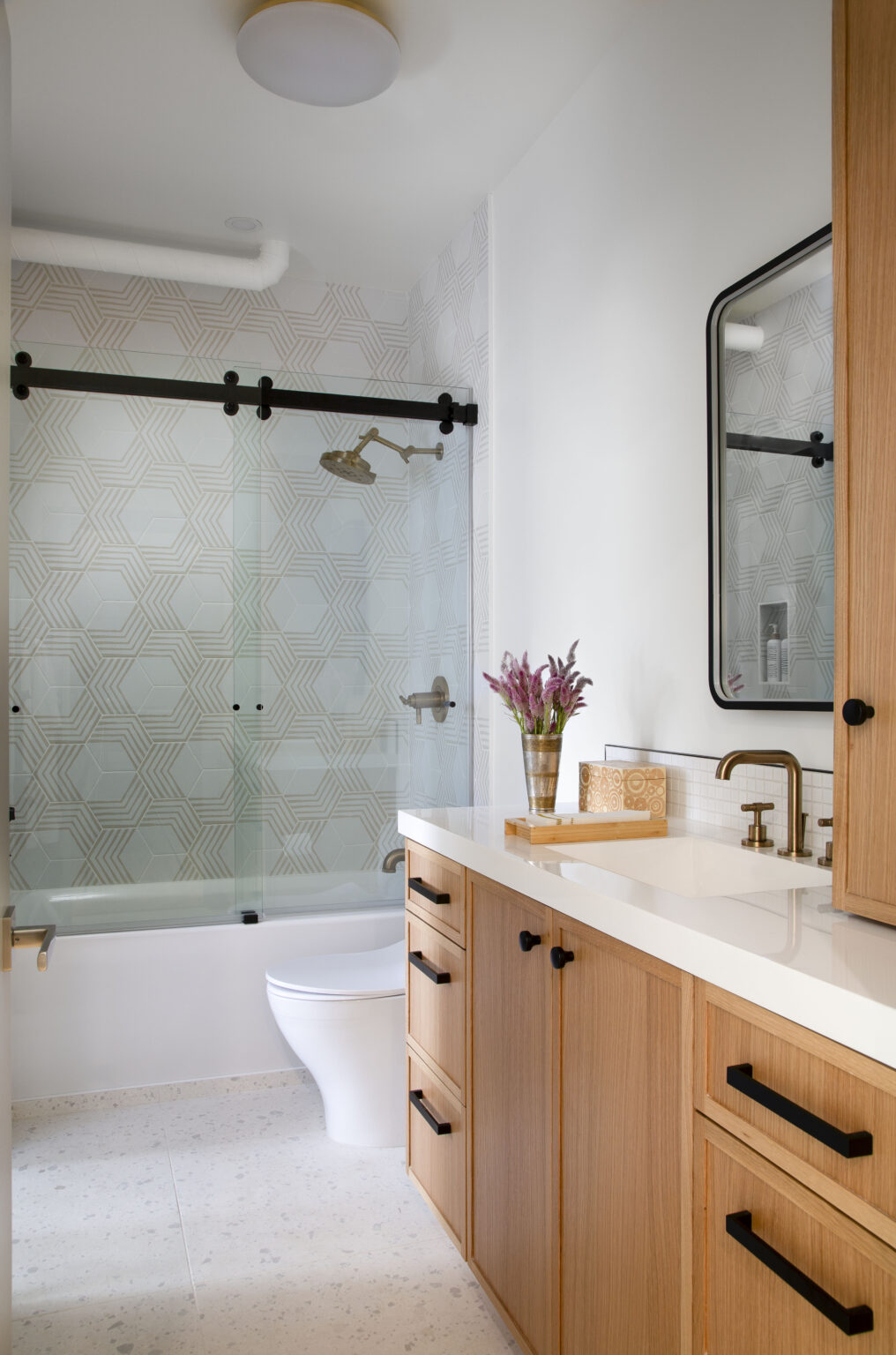 Golden Triangle Hi-Rise guest bath with patterned green tile shower and white oak vanity — company kd