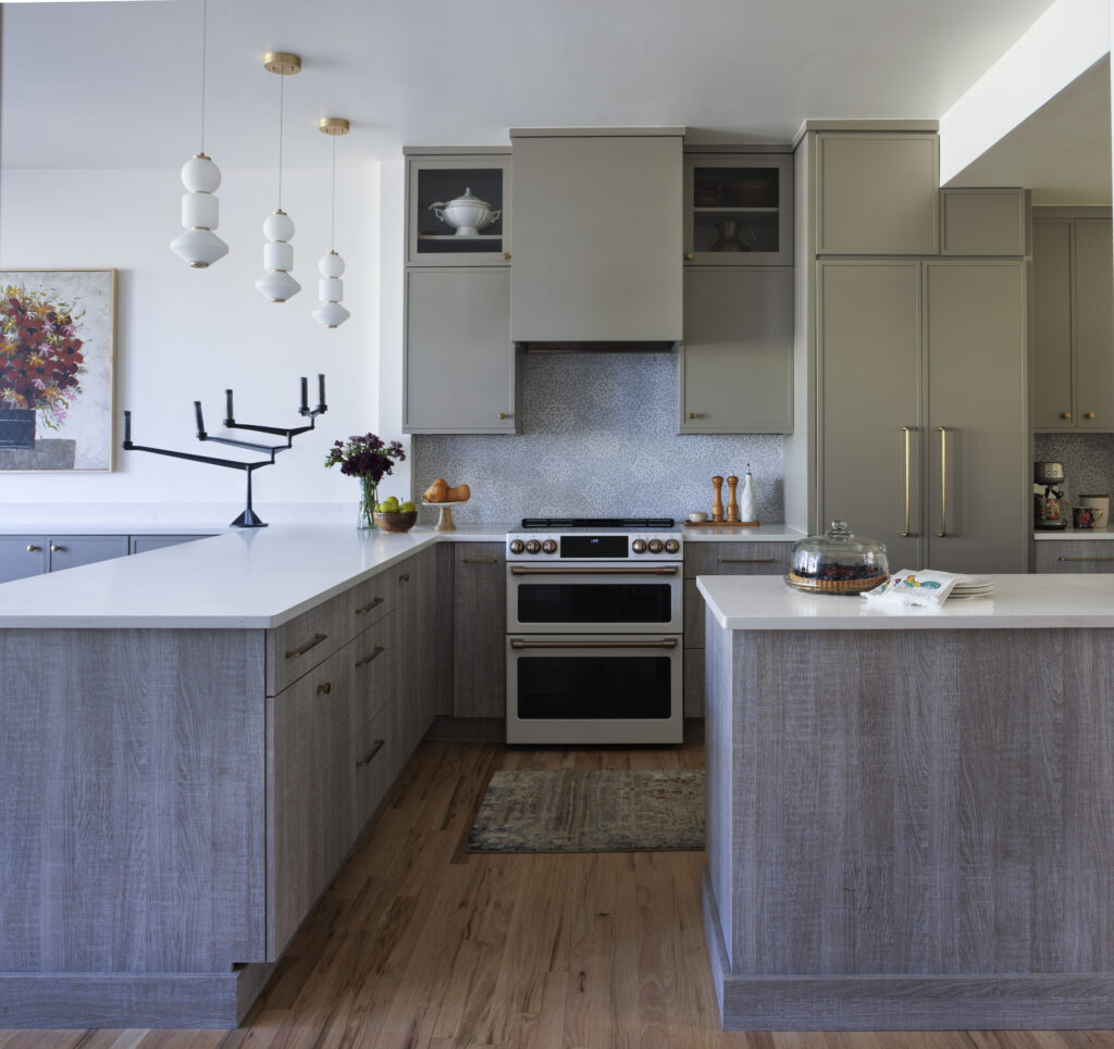 Golden Triangle Hi-Rise kitchen with gray cabinetry, cafe range, and pendant lighting — company kd