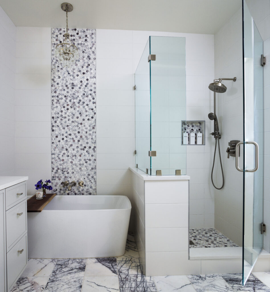 Golden Triangle Hi-Rise primary bath with mosaic tile feature wall and freestanding soaking tub — company kd