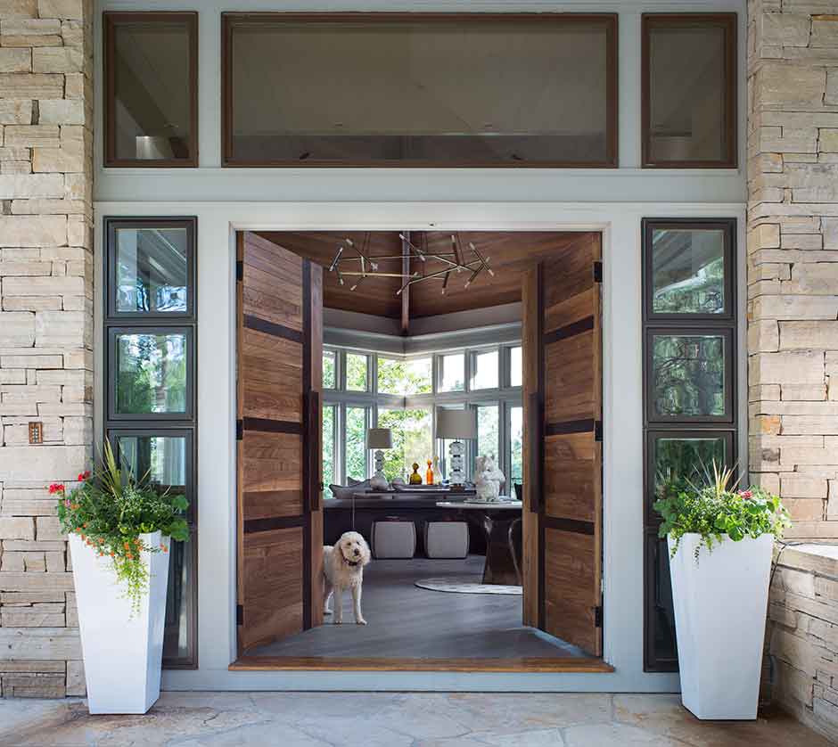 company kd interior design, open wood doors framing a Colorado dining room